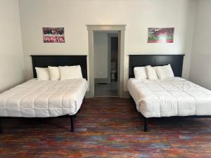 two beds sitting next to each other in a room at All Star Ohio House in Put-in-Bay