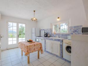 a kitchen with a sink and a washing machine at Holiday Home Mas des Chênes by Interhome in Grimaud +19 photos