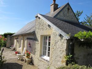 a stone cottage with a window and a roof at Holiday Home Les Lutins by Interhome in Commes +22 photos