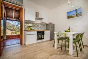 a kitchen and dining room with a table and chairs at Casa vinz in Scopello +22 photos