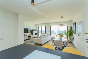 a living room with a dining room table and chairs at 129 Luxury Relax La Mata-Alicante Holiday in La Mata