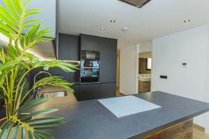 a kitchen with a black table and a plant at 129 Luxury Relax La Mata-Alicante Holiday in La Mata