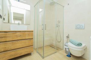 a bathroom with a glass shower and a toilet at 129 Luxury Relax La Mata-Alicante Holiday in La Mata +28 photos