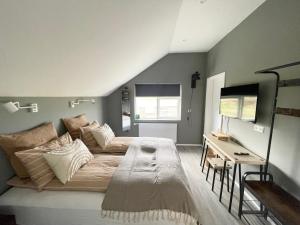 a bedroom with a bed and a desk in it at Lindarhóll Guesthouse in Stóri-Bakki +188 photos