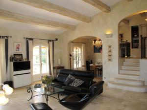 a living room with a couch and a table at Holiday Home Le Mas de la Roche by Interhome in La Môle
