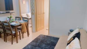 a living room with a table and a dining room at Two Bedroom Condo in Mandurriao Iloilo in Iloilo City