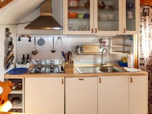 a kitchen with white cabinets and a sink at Apartment Olivo by Interhome in Arnasco