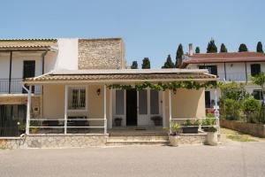 a house with a porch and stairs in front of it at Agatha's spacious modern apt-1 in Perítheia