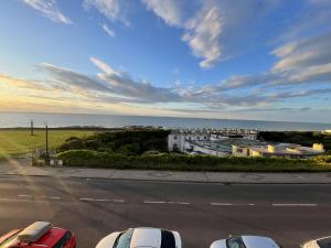 a view of a street with cars parked in a parking lot at Fort Cresent Sea View Apartment in Margate