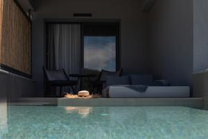 a living room with a bed and a couch and a table at Poseidon Villas in Skiathos Town