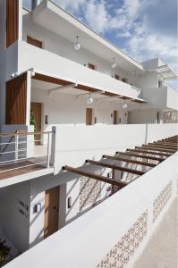 an external view of a white building with stairs at Akti Hotel Kavala in Paleo Tsifliki