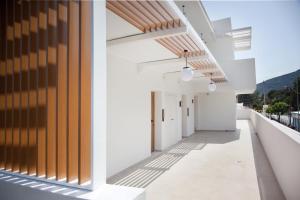 an empty corridor of a building with white walls and wood at Akti Hotel Kavala in Paleo Tsifliki