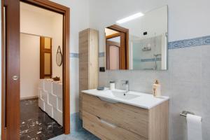 a bathroom with a sink and a mirror at Casa Rosa Aosta in Aosta +16 photos