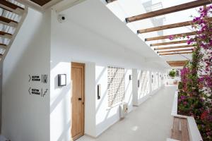 a white hallway with flowers on the walls at Akti Hotel Kavala in Paleo Tsifliki