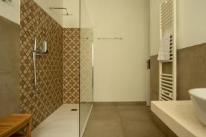 a bathroom with a shower with a glass door at Locanda dei Buoni e Cattivi in Cagliari +92 photos