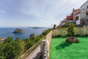 a view of a body of water with a fence at La Finestra sul Castello in Ischia