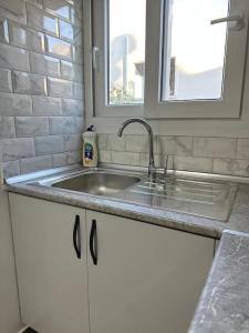 a kitchen counter with a sink and a window at Nıcosıa lefkosa brand new renovated 1 bedroom 3A in Yenişehir