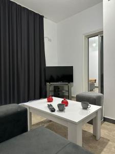 a living room with a white table and two chairs at Nıcosıa lefkosa brand new renovated 1 bedroom 3A in Yenişehir