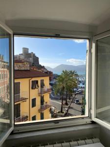 a window with a view of a city street at Bussola In Holidays - Lerici in Lerici