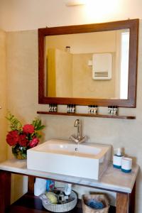 a bathroom with a sink and a mirror at Charming Vourkari Stone Home 1 - Minutes from port in Vourkari