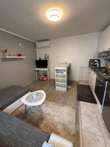a living room with a couch and a table at Apartman Indy in Marčelji