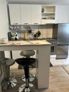a kitchen with a counter and two bar stools at Apartman Indy in Marčelji