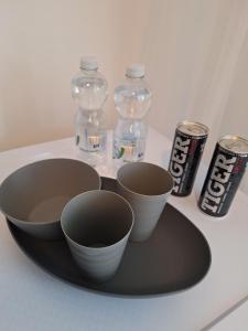 a tray with bowls and bottles of water and soda cans at Hotelak Martinov in Ostrava +7 photos