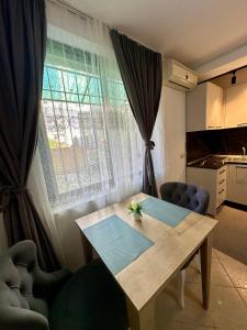 a dining room table in front of a window at Krid Tirana Studio Flat in Tirana +7 photos