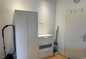 a kitchen with a white cabinet and a sink at Beautiful Apartment in Düren in Düren - Eifel