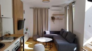 a small living room with a couch and a table at Royal Villa - HAWAII in Vrnjačka Banja