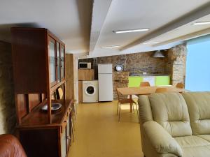 a living room with a couch and a table at A Casiña do Río in Neda