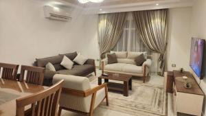 a living room with a couch and a table at Madinaty apartment شقة فندقية مفروشة سوبر لوكس في مدينتي in Madinaty