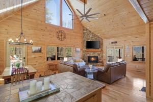 a living room and dining room with a fireplace in a cabin at The Remedy at Blue Ridge - mountain view cabin with hot tub and two fire pits in Cherry Log