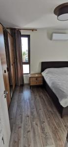 a bedroom with a bed and a wooden floor at Aх, морето in Burgas City