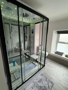 a room with a glass room with a bathroom at Quaint cottage close to Marina in Pembrokeshire