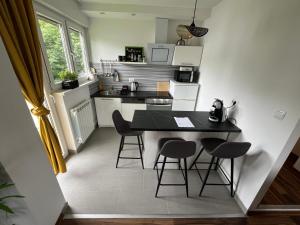 a small kitchen with a black table and chairs at Eva Luxury Rooms & Apartments in Plitvička Jezera