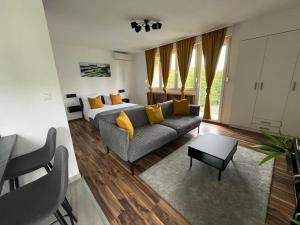 a living room with a couch and a bed at Eva Luxury Rooms & Apartments in Plitvička Jezera