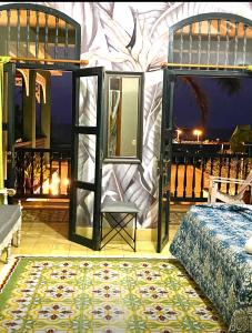 a bedroom with a bed and a door with a window at Hotel Boutique Castillo Ines Maria in Cartagena de Indias