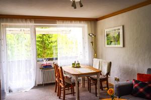 a living room with a table and a window at FeWo AllgäuZeit mit Hallenbad & Sauna & kostenlosem WLAN in Missen-Wilhams