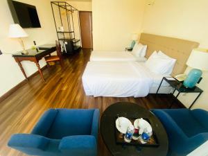 a hotel room with a bed and a table and chairs at Liberty 2 Hotel in Ho Chi Minh City