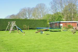 a park with a playground with a swing at Ferienwohnung Nr 3 in Hinrichsdorf