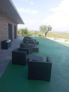 a group of chairs sitting on top of a lawn at Cabezo Buñuel alojamiento Rural in Calanda