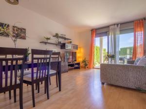 a living room with a table and a couch at Apartment Viena 13 by Interhome in L'Ampolla