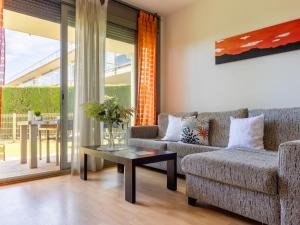 a living room with a couch and a table at Apartment Viena 13 by Interhome in L'Ampolla +26 photos