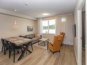 a dining room and living room with a table and chairs at Holiday Home Levistar vi as- 6106 by Interhome in Levi