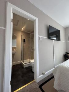 a bathroom with a shower and a toilet in a room at The Glendevon Hotel in Auchterarder