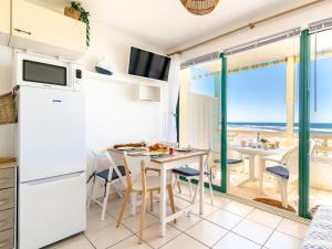 a kitchen and dining room with a table and chairs at Apartment Cap Océan-8 by Interhome in Mimizan