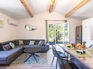 a living room with a couch and a table at Holiday Home Casa Germaine by Interhome in Porto-Vecchio