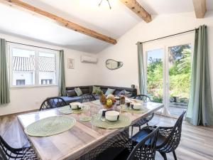 a dining room with a large wooden table and chairs at Holiday Home Casa Germaine by Interhome in Porto-Vecchio