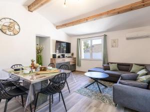 a living room with a couch and a table at Holiday Home Casa Germaine by Interhome in Porto-Vecchio +21 photos